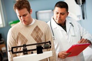 physician weighing client overweight