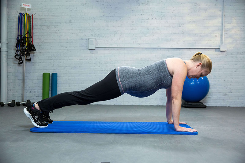 woman performing core exercises while pregnant